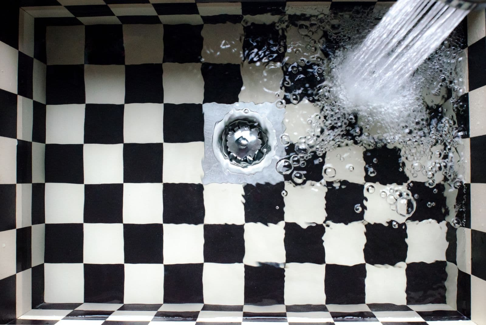 Water swirling into a sink drain